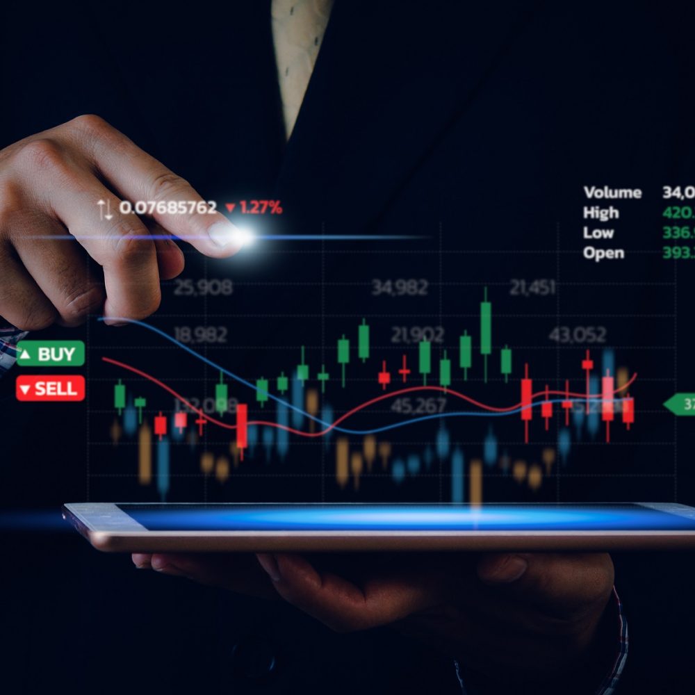Stock market chart business using a tablet to analyze online trading data.Forex graph financial and investment on a virtual screen concept.